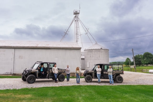 The Hageman Realty brokerage team at grain bins on Indiana farmland