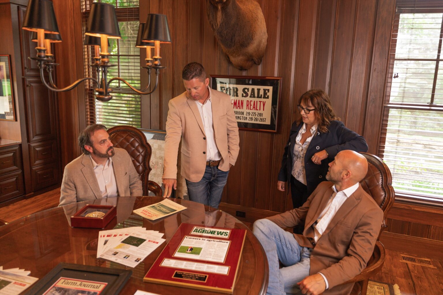 Hageman Realty team members meeting around a conference table in the office