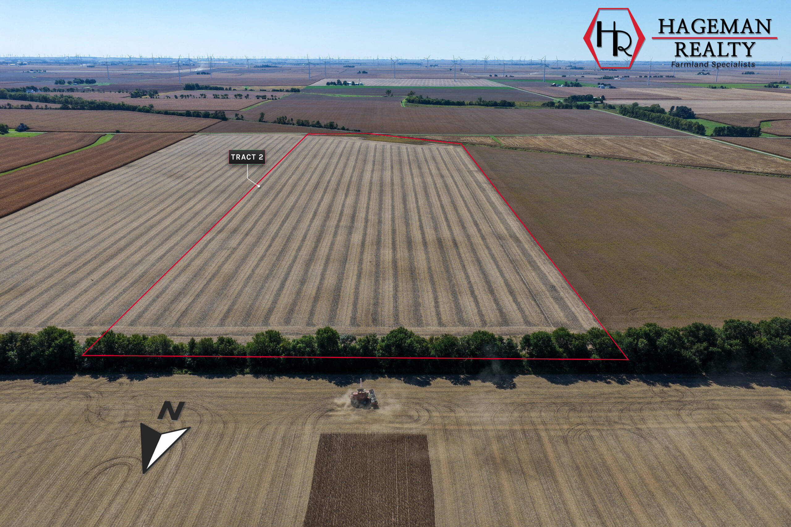Portteus Farm Tract 2 outlined in red behind a tree line, with a combine harvesting the neighboring field