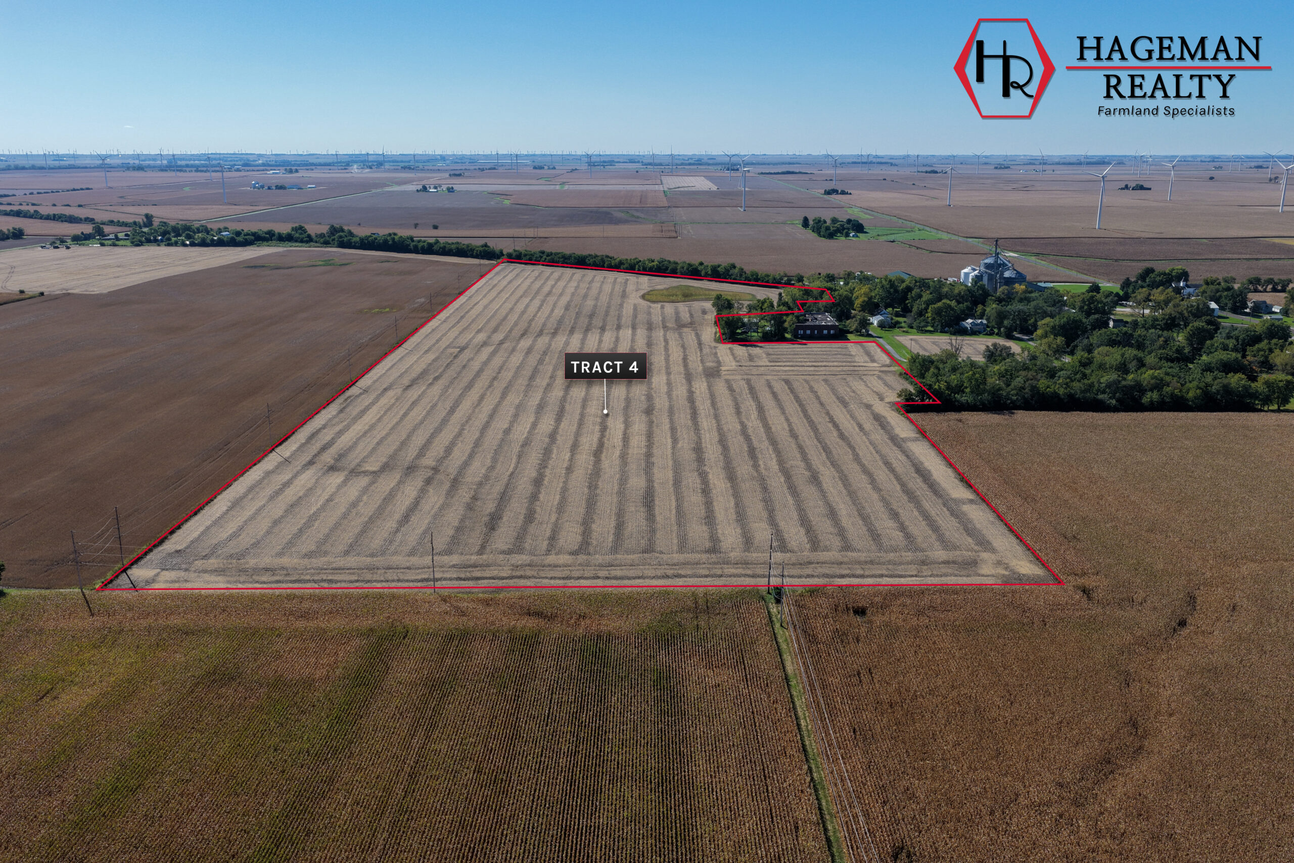 Wide aerial of Portteus Farm Tract 4 cropland bordered by trees and homes on the edge of Raub, Indiana