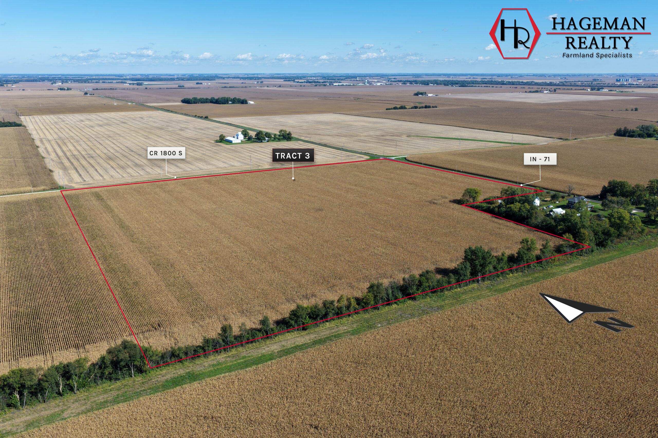 Closer aerial of Portteus Farm Tract 3 cropland with a tree line and a farmstead outside the red boundary